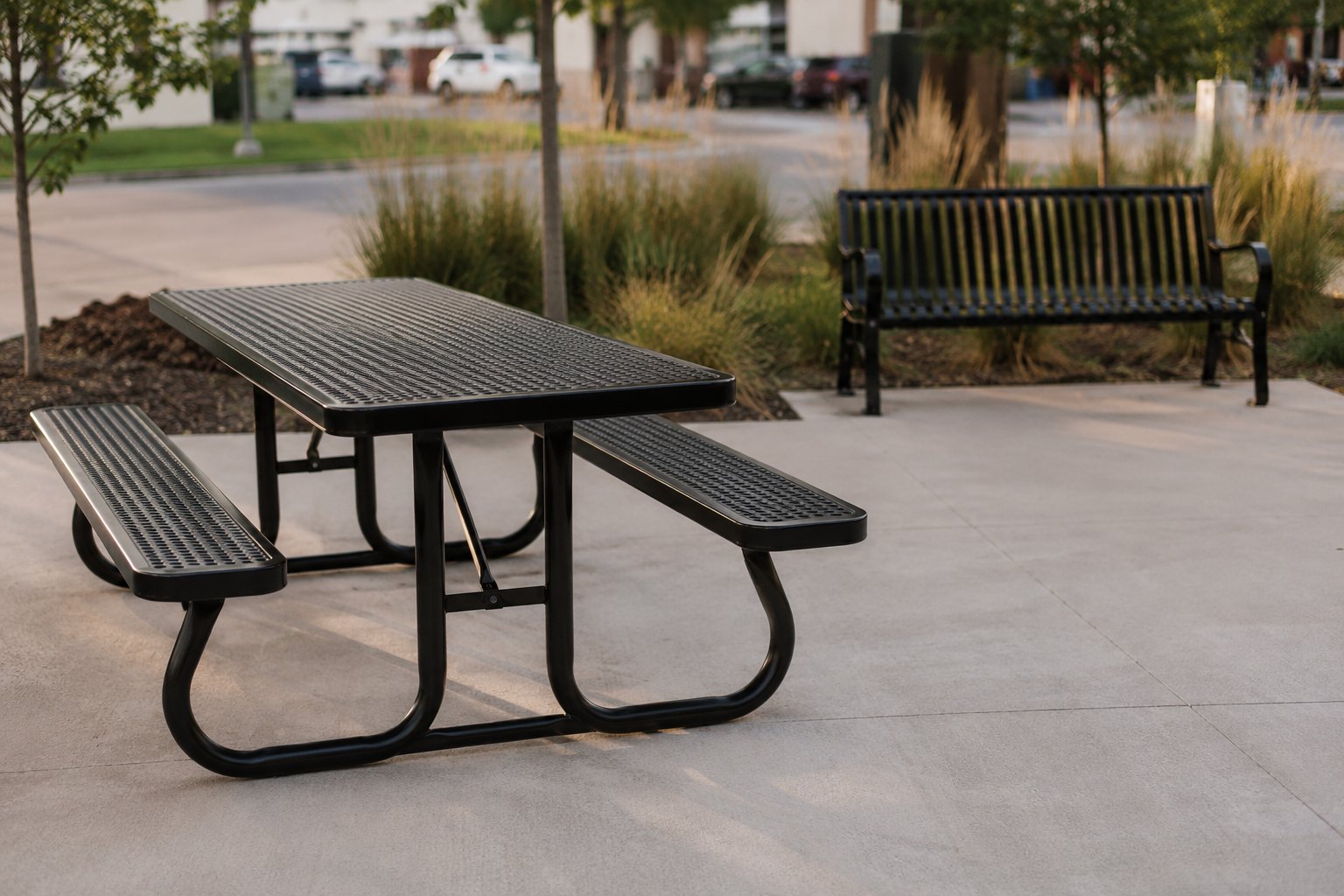 Powder coated steel picnic table and bench outside a commercial building